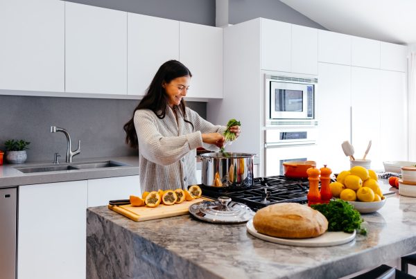 Happy woman cooking at home — vitamins b complex article