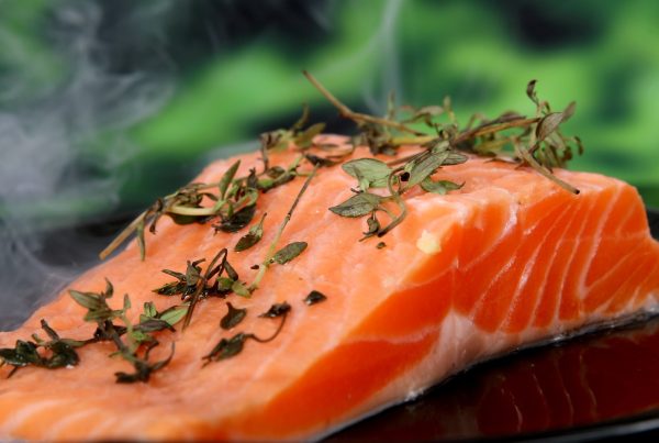 smoked salmon with herbs in a plate - picture used in article about omega-3 health benefits