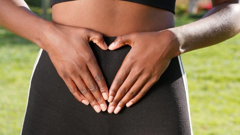 omega-3 gut benefits - a woman caressing her gut