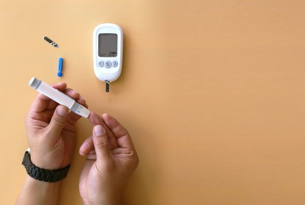 a person measuring his blood glucose metabolism