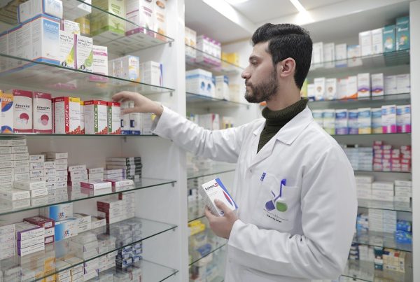 a male pharmacist in a pharmacy - picture used in article on german pharmacies