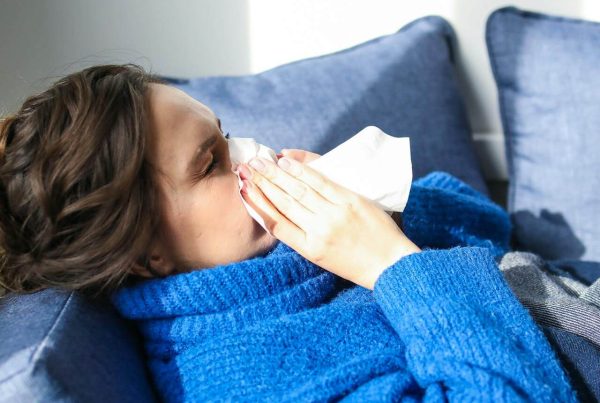 Woman in Blue Sweater Lying on Bed sick - used in article on Salbutamol benefits