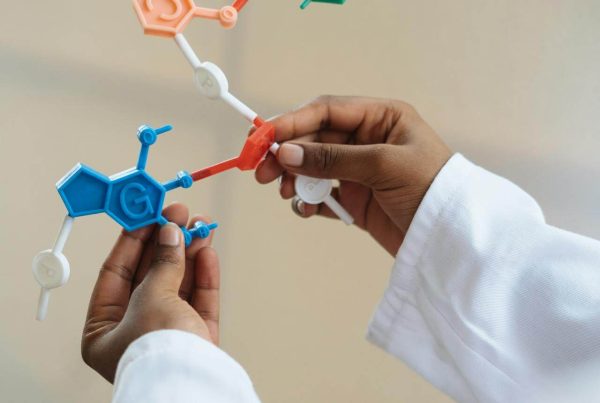 Crop chemist holding in hands molecule model - used in article on mvs pharma hesperidin AGH supplement