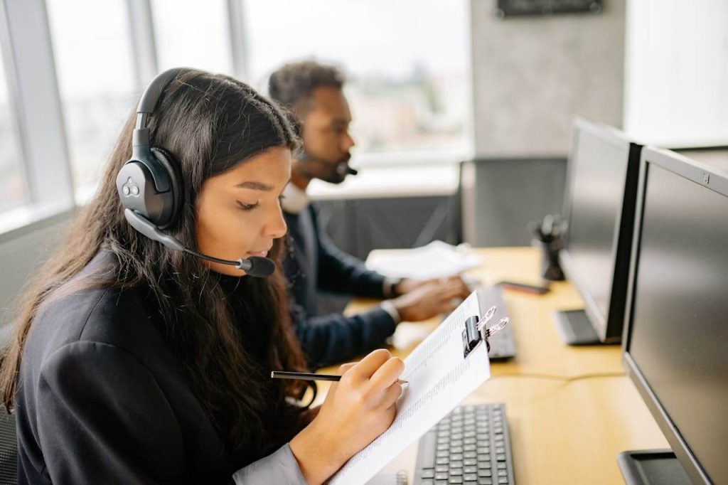 Woman With Headset Holding A Clipboard and Taking Notes - used in article on Complaint Management